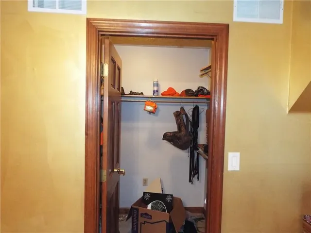 a close view of a utility room with a sink and mirror