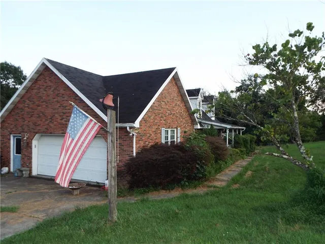 a view of house with backyard and garden