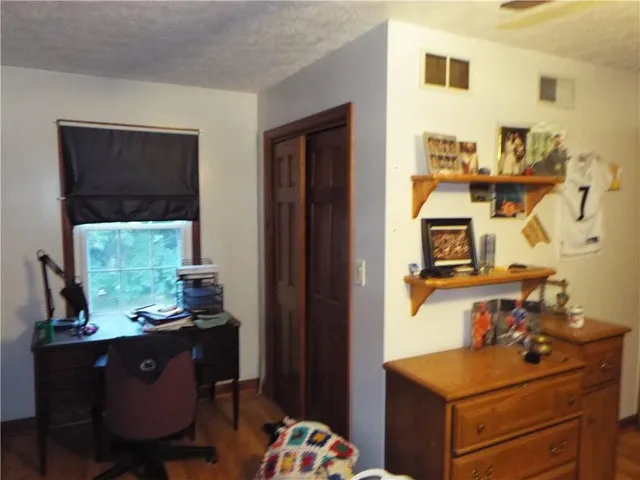 a room with furniture a window and a flat screen tv