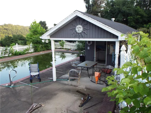 a view of a house with backyard sitting area and garden