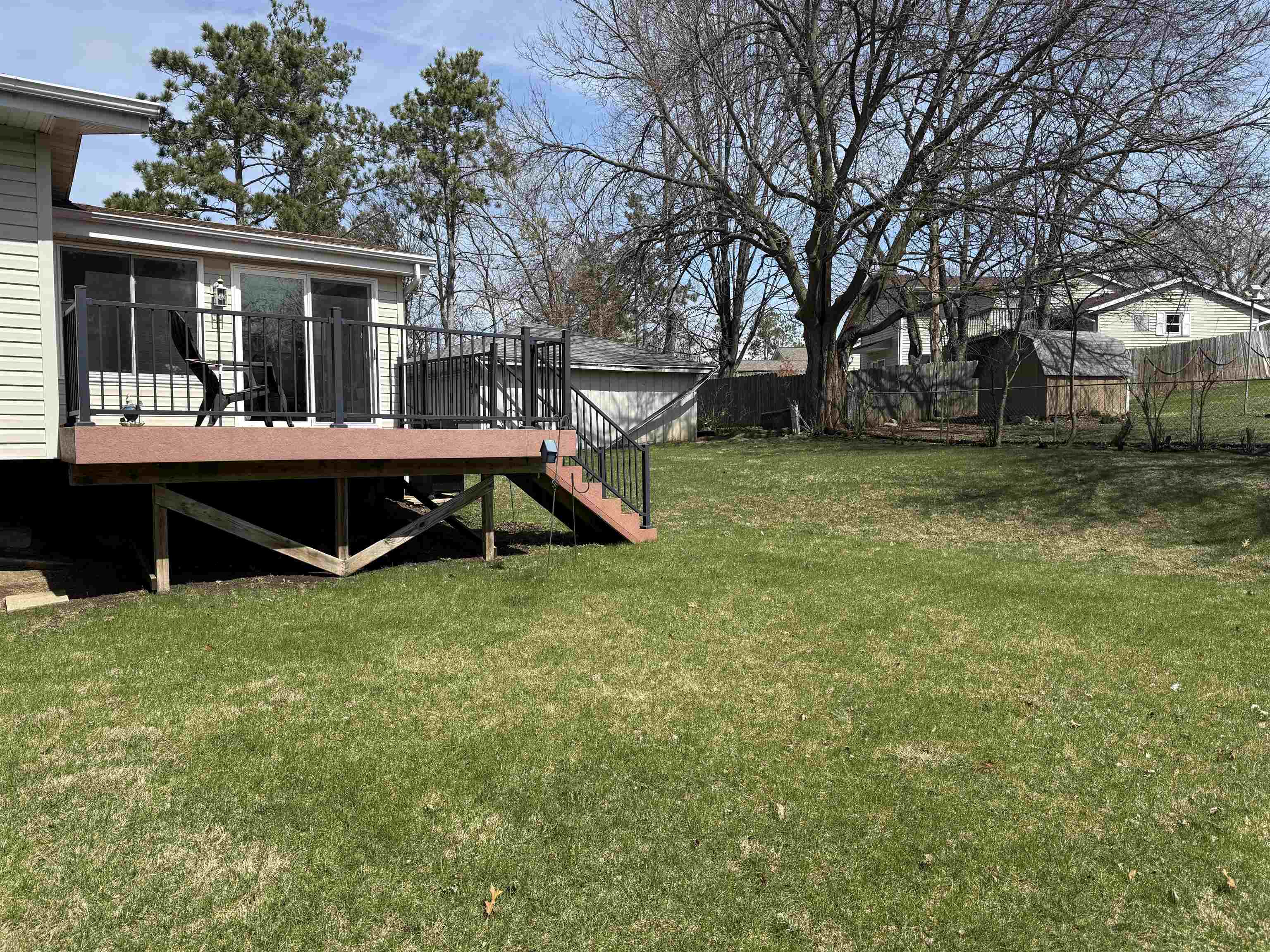 2822 Norway Pine Road Rockford, IL 61109 - Photo 16 of 18 a view of backyard with large trees and wooden fence