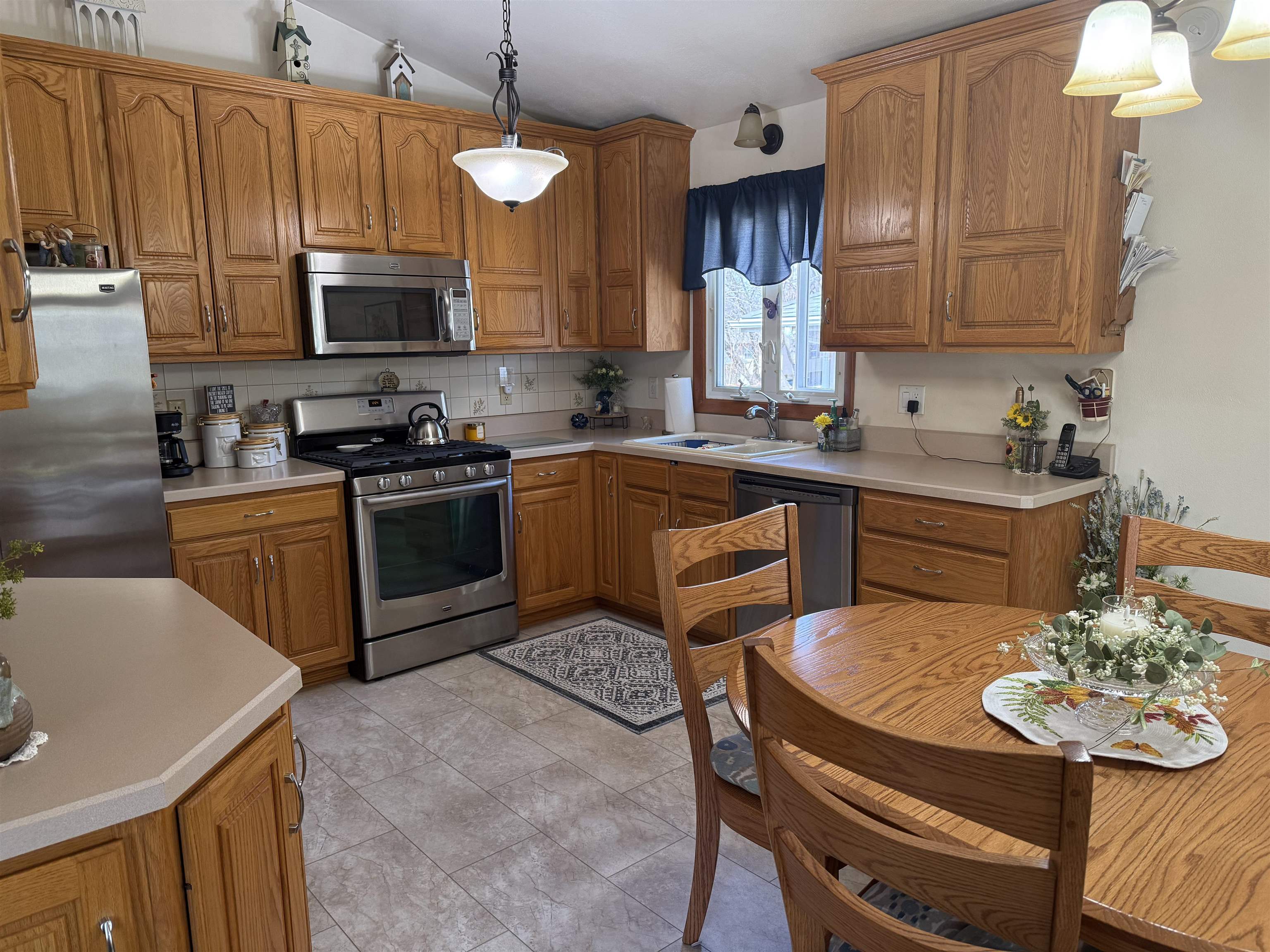 2822 Norway Pine Road Rockford, IL 61109 - Photo 2 of 18 a kitchen with stainless steel appliances a stove a sink a microwave a refrigerator and cabinets
