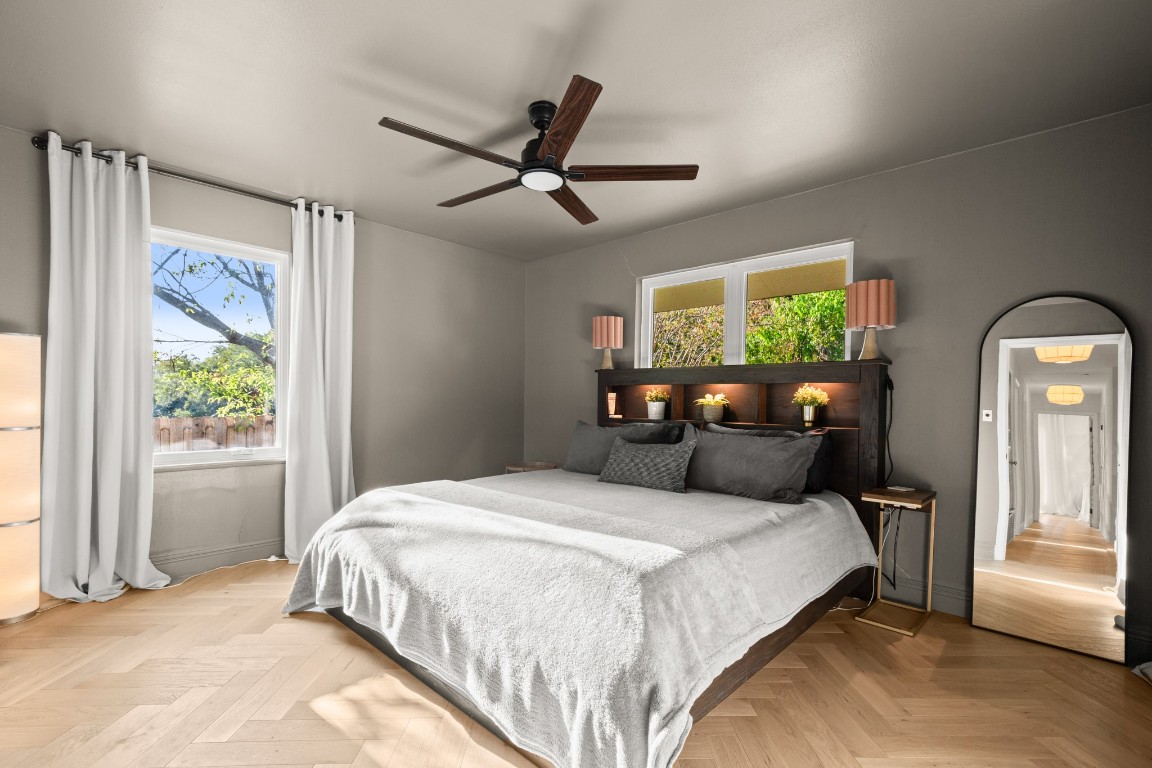 1617 Elmhurst Drive Austin, TX 78741 - Photo 29 of 32 a bedroom with a bed and wooden floor