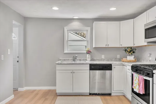 a kitchen with stainless steel appliances granite countertop a sink and a stove top oven