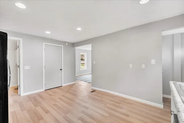 a view of an empty room with wooden floor