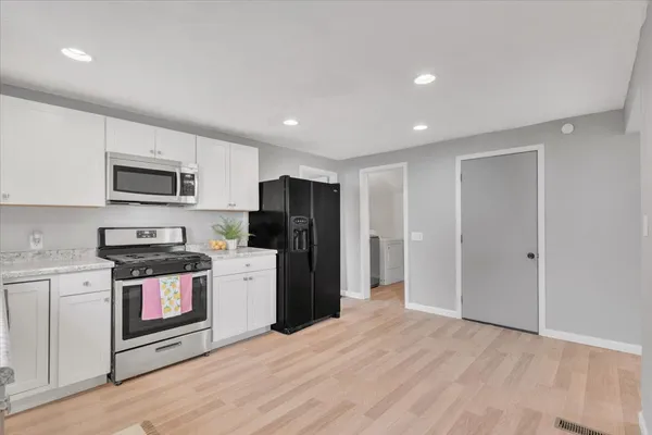 a kitchen with a refrigerator a stove top oven a sink and dishwasher