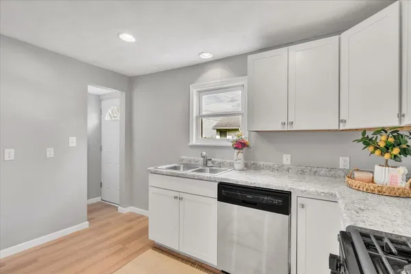 a kitchen with stainless steel appliances granite countertop a sink stove and cabinets