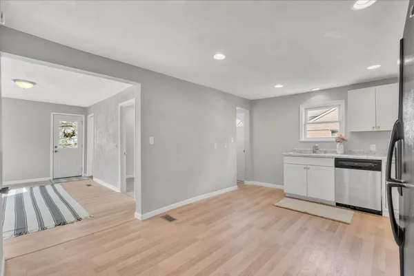 a kitchen with stainless steel appliances granite countertop a refrigerator and a sink