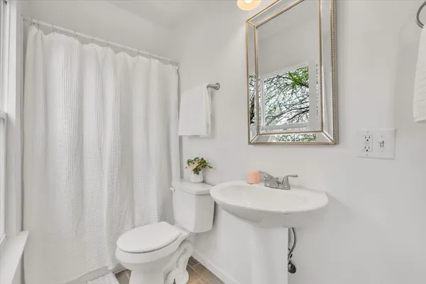 a bathroom with a sink toilet and a mirror