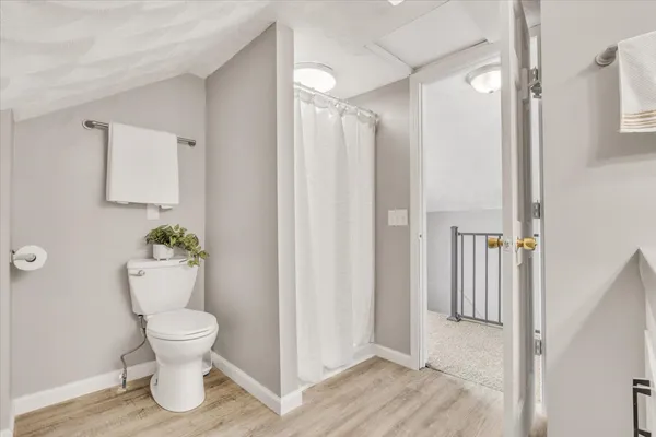 a bathroom with a toilet and a shower