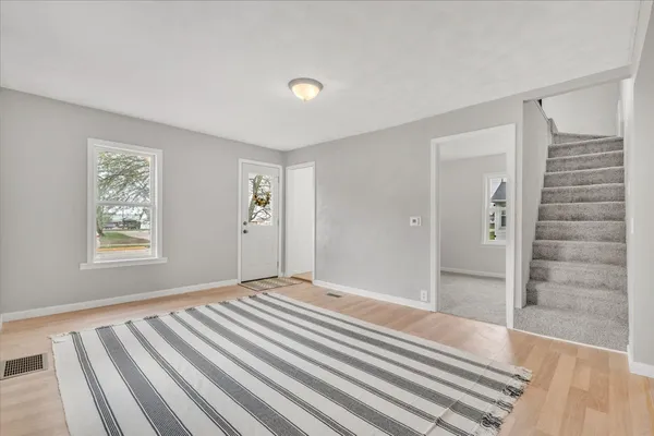 a view of wooden floor and windows in a room