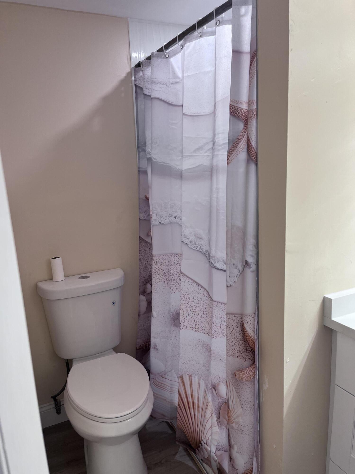 251 South Golf Boulevard, Unit 294 Pompano Beach, FL 33064 - Photo 14 of 36 a white toilet sitting next to a bathroom sink