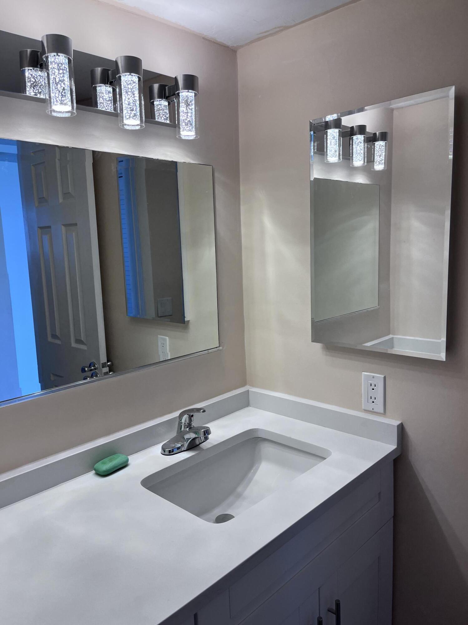 251 South Golf Boulevard, Unit 294 Pompano Beach, FL 33064 - Photo 15 of 36 a bathroom with a sink and a mirror