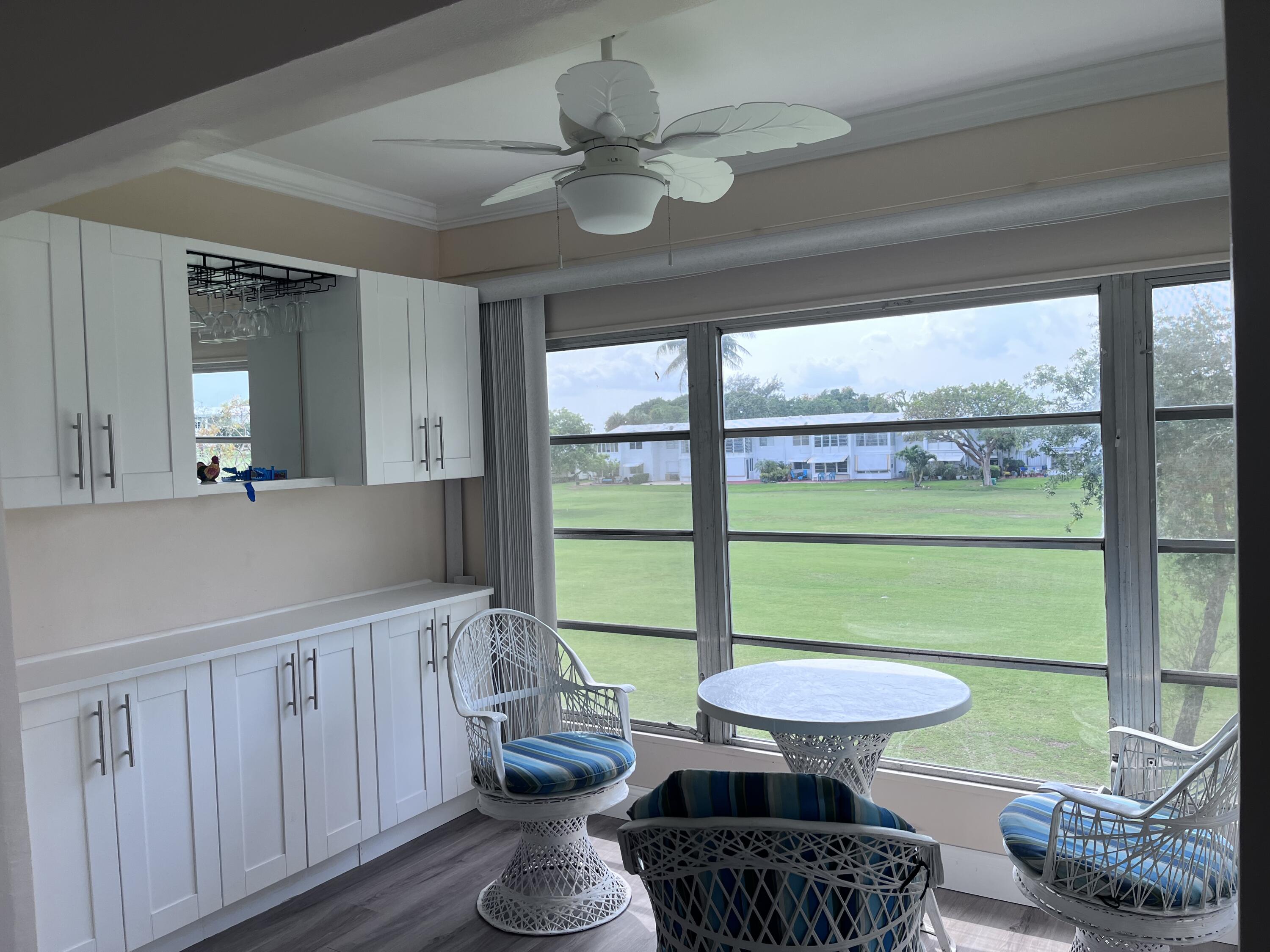 251 South Golf Boulevard, Unit 294 Pompano Beach, FL 33064 - Photo 2 of 36 a room with furniture and a large window