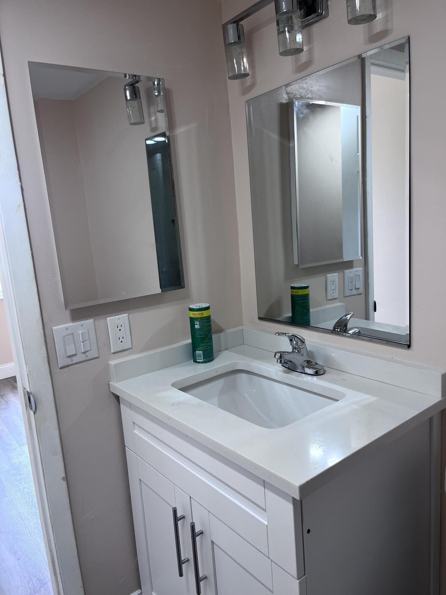 251 South Golf Boulevard, Unit 294 Pompano Beach, FL 33064 - Photo 21 of 36 a bathroom with a sink and a mirror