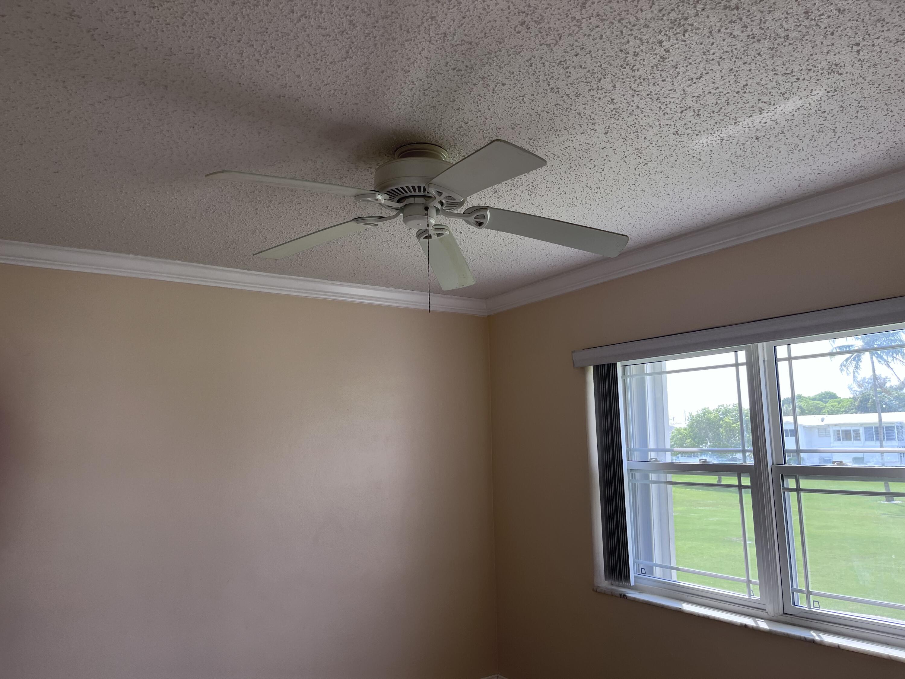 251 South Golf Boulevard, Unit 294 Pompano Beach, FL 33064 - Photo 24 of 36 an empty room with windows and fan