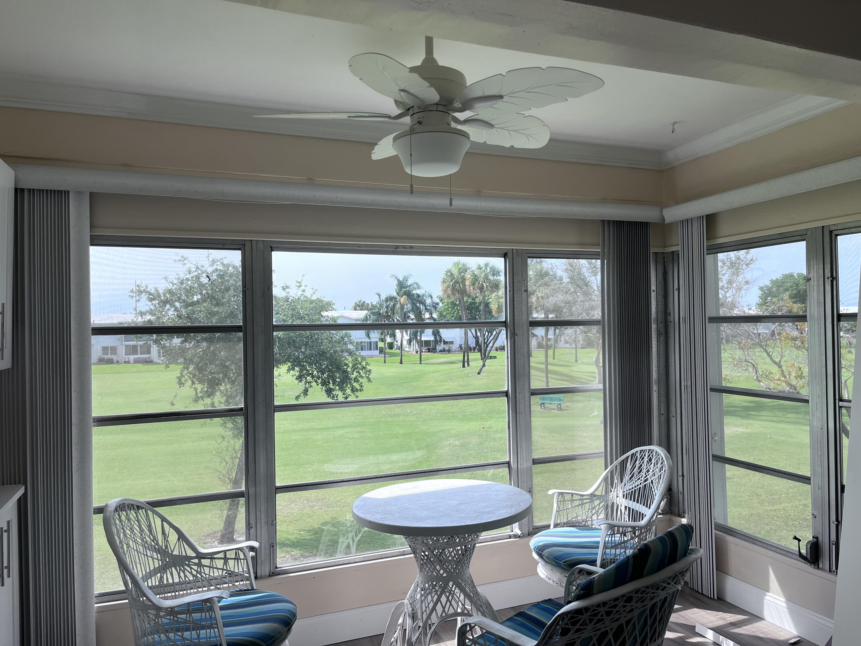 251 South Golf Boulevard, Unit 294 Pompano Beach, FL 33064 - Photo 25 of 36 a room with furniture and a large window