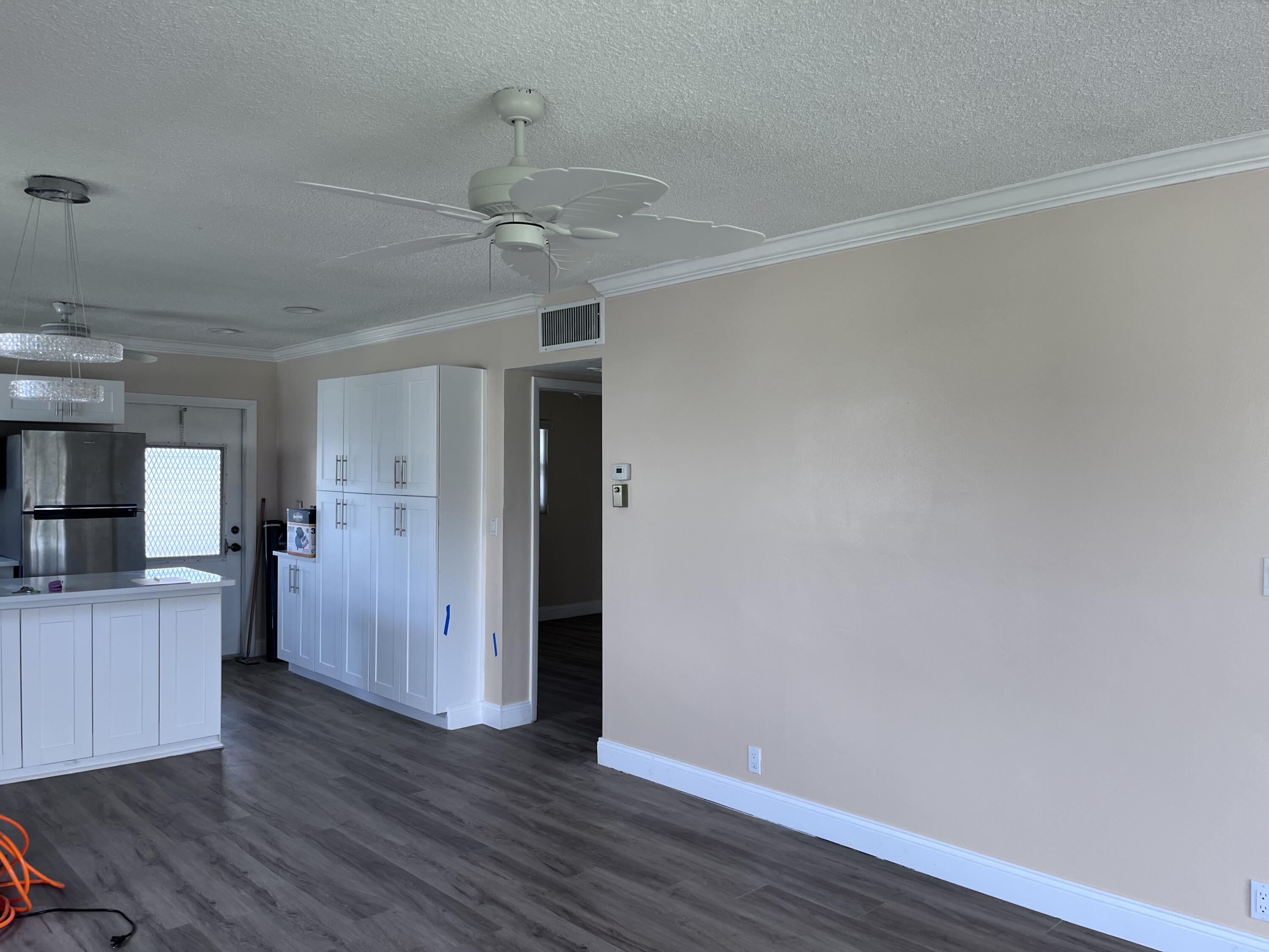 251 South Golf Boulevard, Unit 294 Pompano Beach, FL 33064 - Photo 3 of 36 a view of a kitchen with a refrigerator and a stove top oven