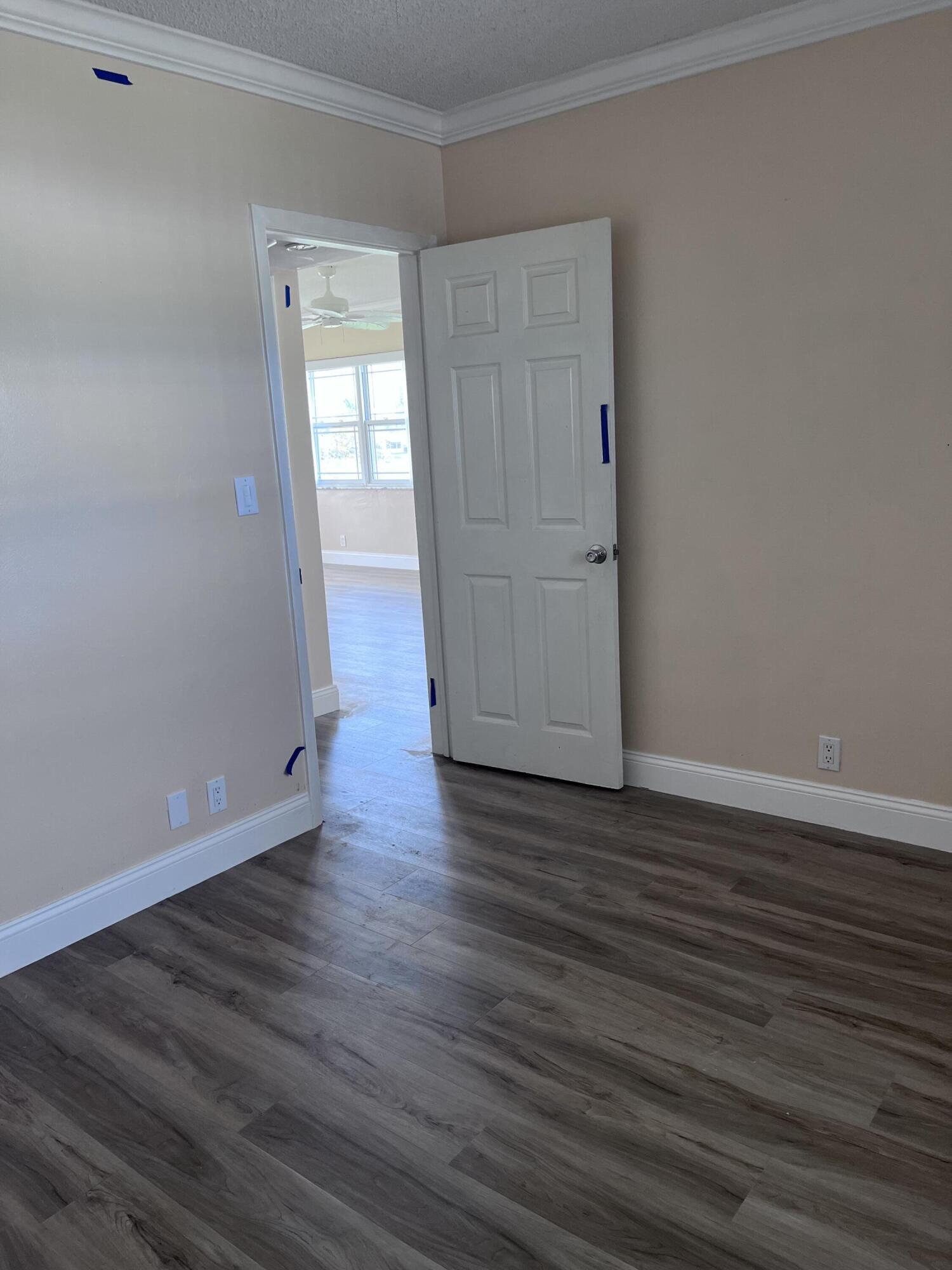251 South Golf Boulevard, Unit 294 Pompano Beach, FL 33064 - Photo 9 of 36 a view of a room with wooden floor and window