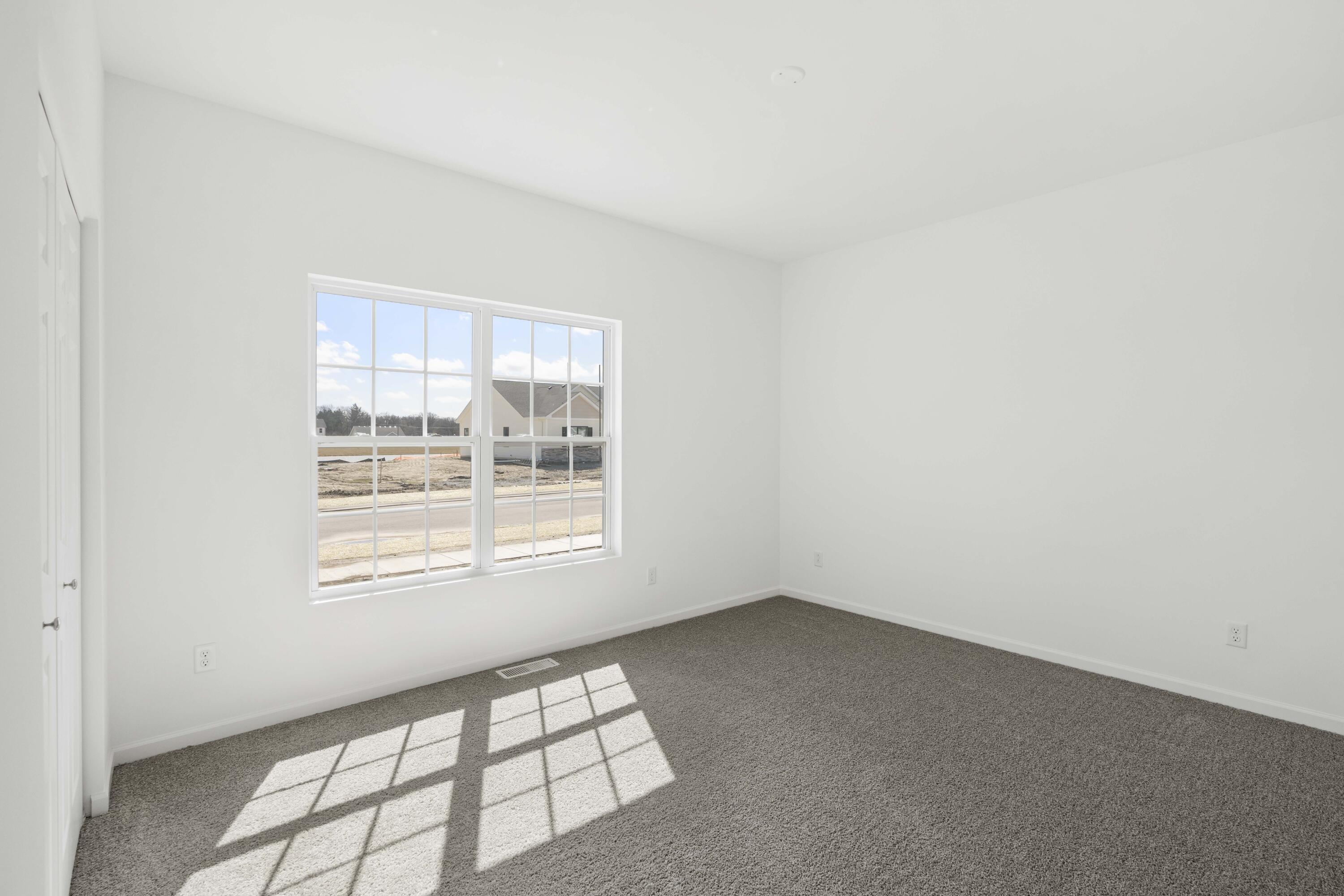 6711 East 103rd Avenue Crown Point, IN 46307 - Photo 3 of 13 an empty room with a window