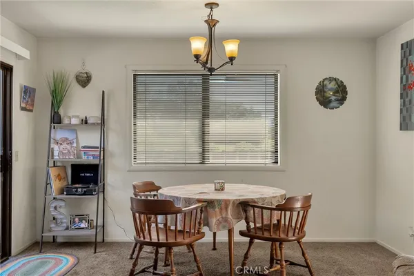 a dining room with furniture and window