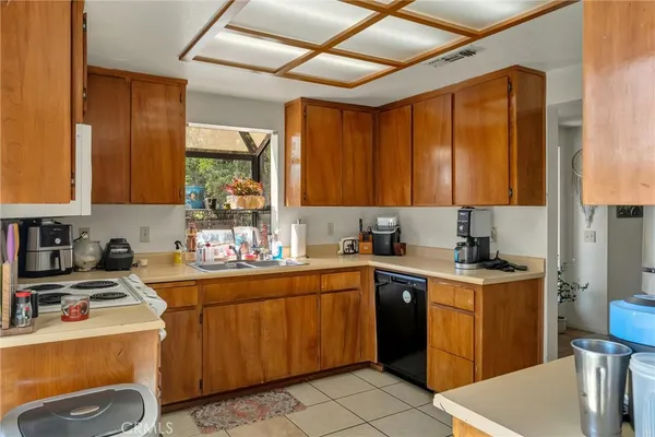 a kitchen with a sink a stove and cabinets