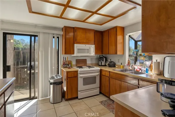a kitchen with a sink appliances and cabinets