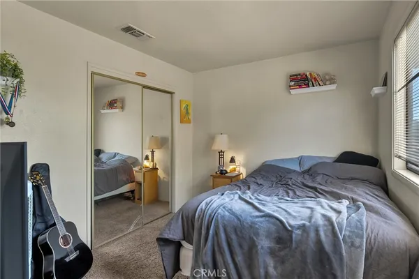 a bedroom with a bed and a book shelf