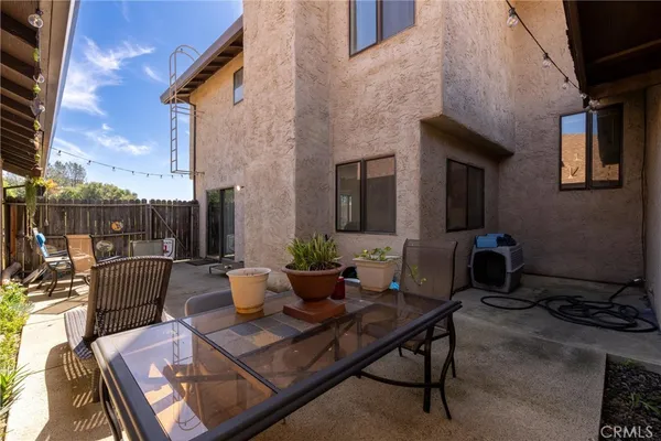 a view of a patio with couches and potted plants