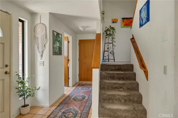 a view of entryway with furniture and wooden floor