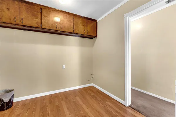 a view of a room with wooden floor