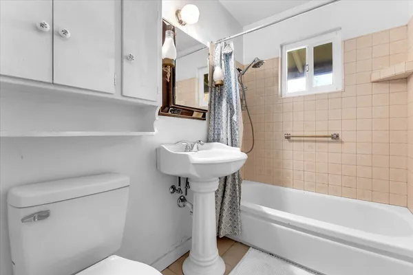 a bathroom with a sink a toilet and bathtub