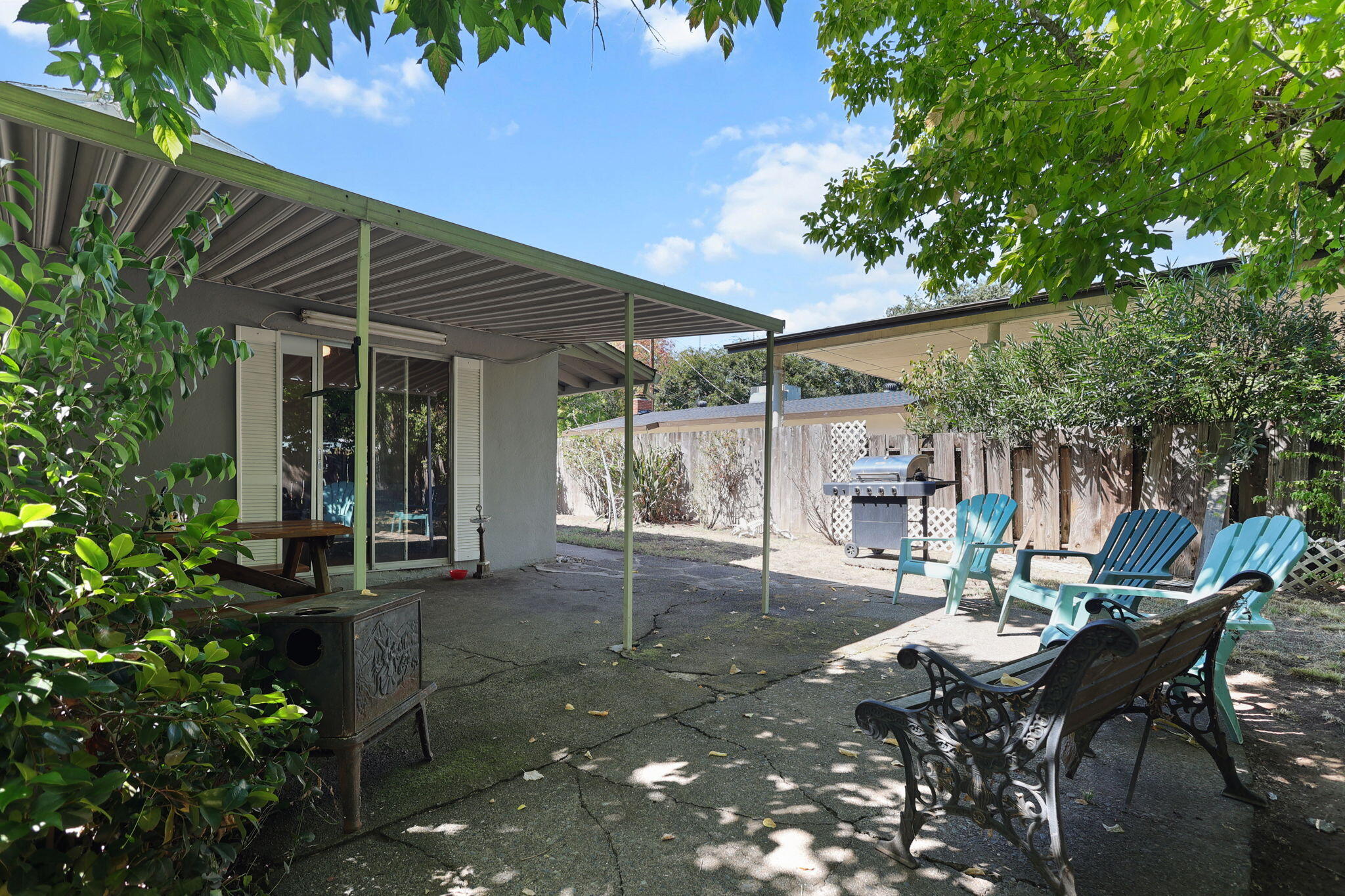 2165 Paris Avenue Redding, CA 96001 - Photo 21 of 22 a view of a patio with table and chairs and potted plants