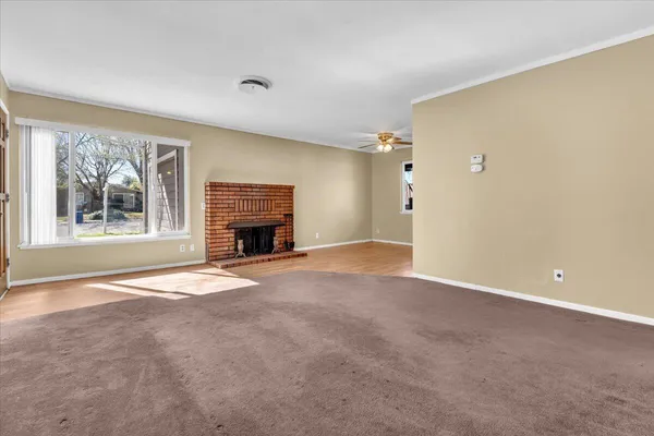 a view of empty room with a fireplace