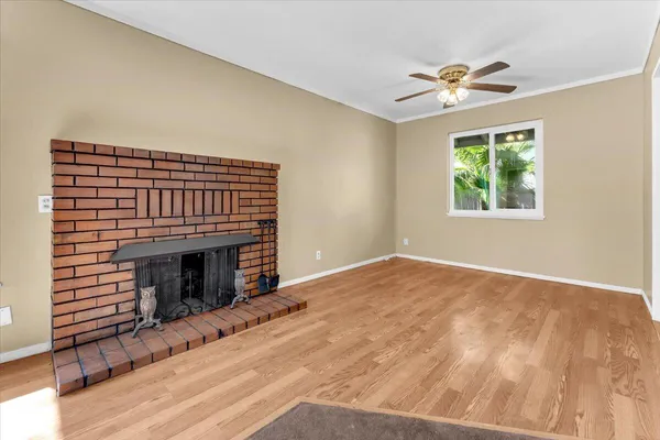 a view of empty room with fan and window