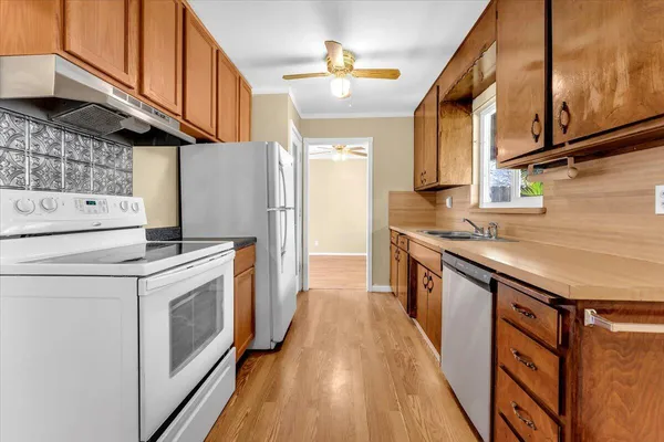 a kitchen with a stove a sink and a refrigerator