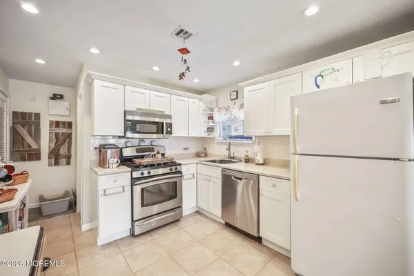a white refrigerator freezer sitting inside of a kitchen