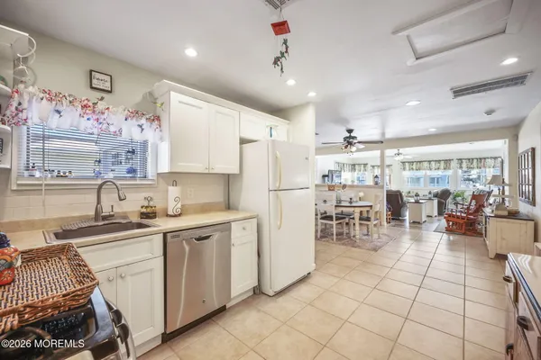 a kitchen with cabinets and chairs