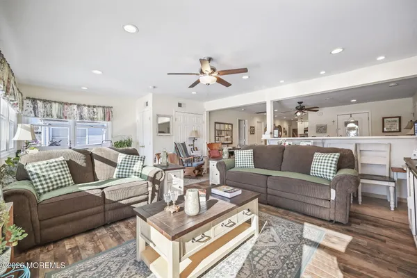 a living room with furniture a rug and a chandelier