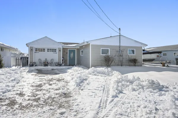 a view of a house with a yard covered in snow