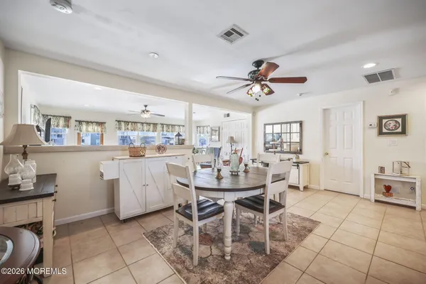 a dining room with furniture and window
