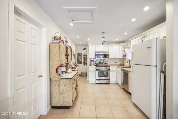 a kitchen with refrigerator and cabinets