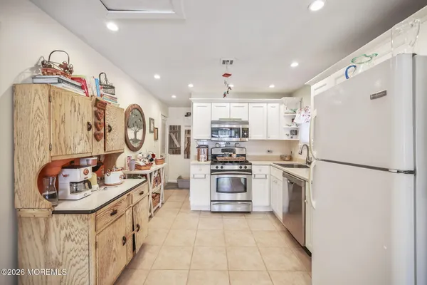 a kitchen with stainless steel appliances granite countertop a refrigerator sink stove and microwave
