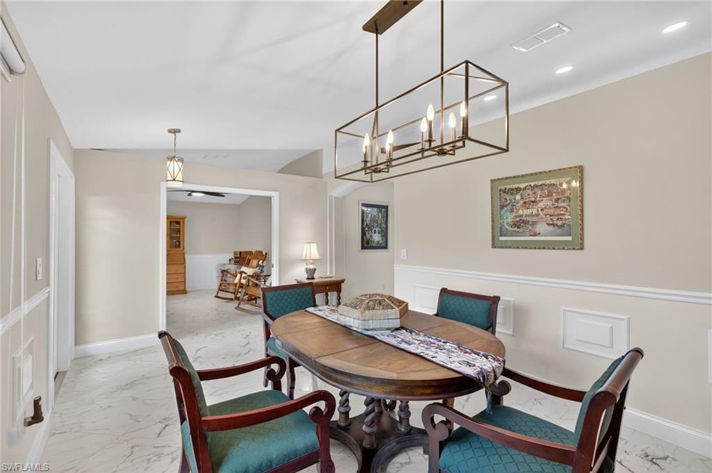 1741 17th Street Southwest Naples, FL 34117 - Photo 11 of 50 Dining room with light satin finish porcelain tile flooring, lofted ceiling, and recessed lighting
