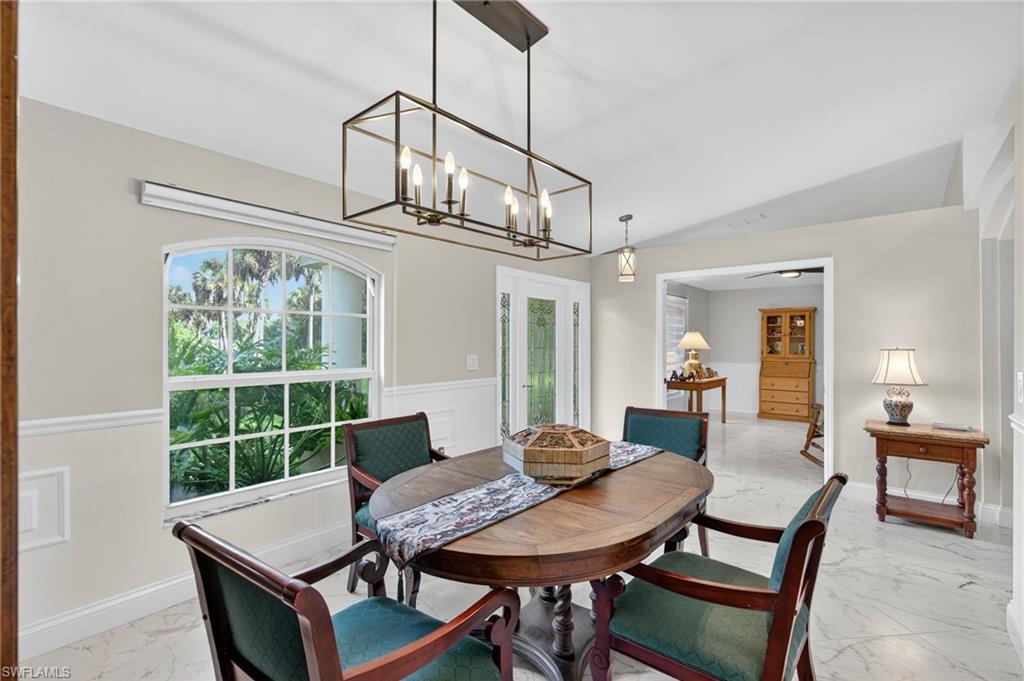 1741 17th Street Southwest Naples, FL 34117 - Photo 12 of 50 Dining space with light satin finish porcelain tile flooring