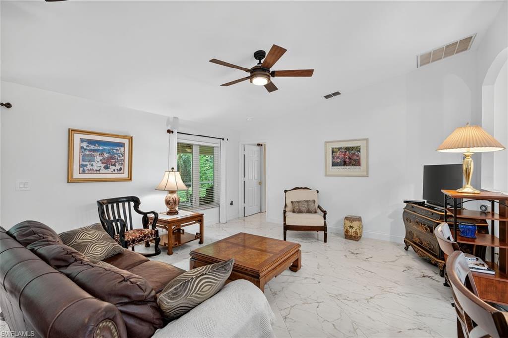 1741 17th Street Southwest Naples, FL 34117 - Photo 20 of 50 Living room with a ceiling fan and light satin finish porcelain tile flooring