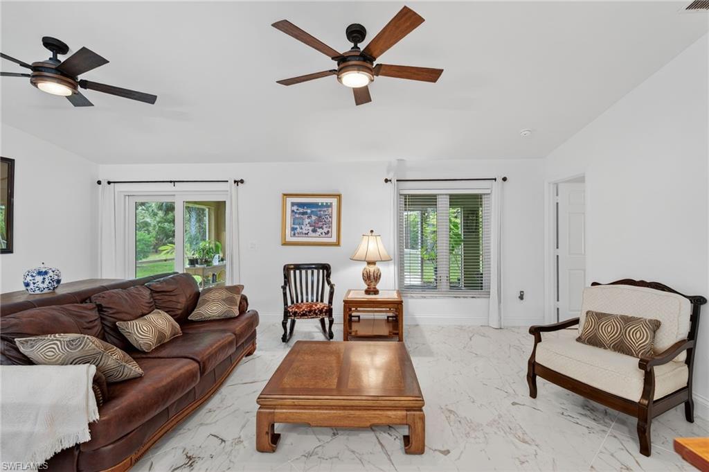 1741 17th Street Southwest Naples, FL 34117 - Photo 21 of 50 Living area featuring light satin finish porcelain tile flooring and lofted ceiling