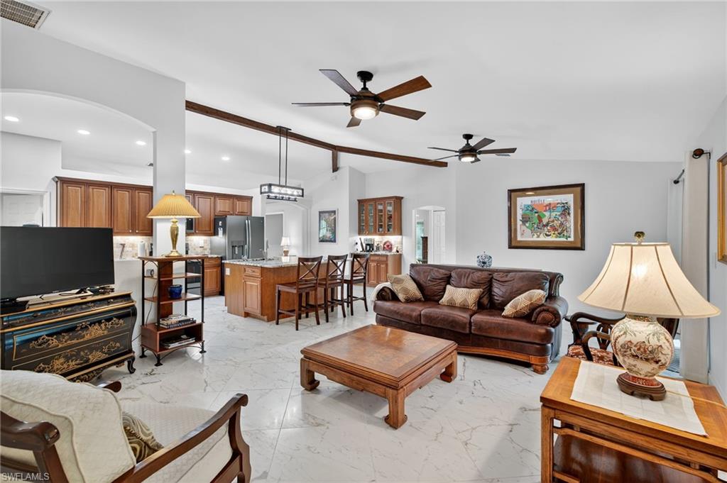 1741 17th Street Southwest Naples, FL 34117 - Photo 23 of 50 Living area with arched walkways, light satin finish porcelain tile flooring, and ceiling fan