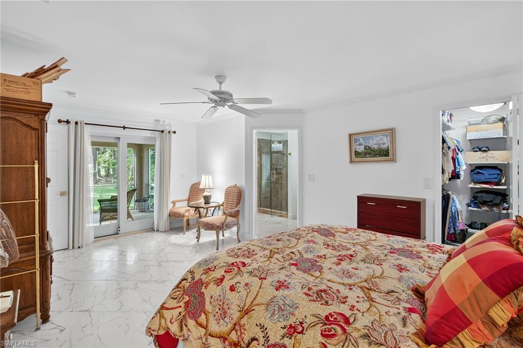 1741 17th Street Southwest Naples, FL 34117 - Photo 25 of 50 Bedroom with light satin finish porcelain tile flooring, a walk in closet, crown molding, access to exterior, and a ceiling fan