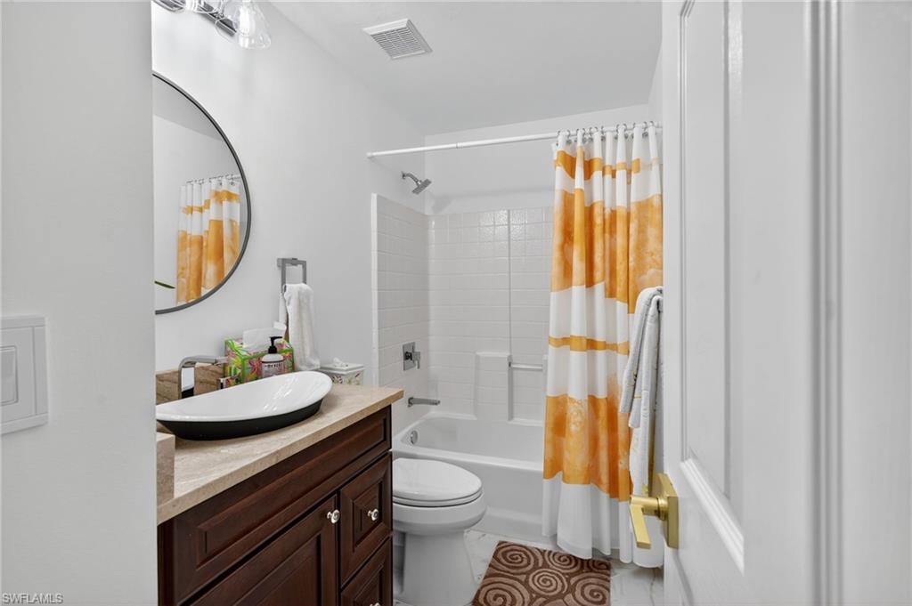 1741 17th Street Southwest Naples, FL 34117 - Photo 32 of 50 Full bath featuring vanity, shower / bathtub combination with curtain, and light satin finish porcelain tile flooring